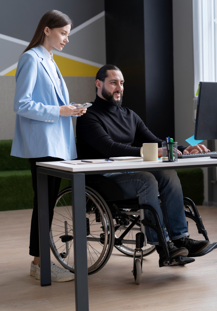 support worker helping participants with Assist Access & Maintain Employment Support services in a professional workplace environment